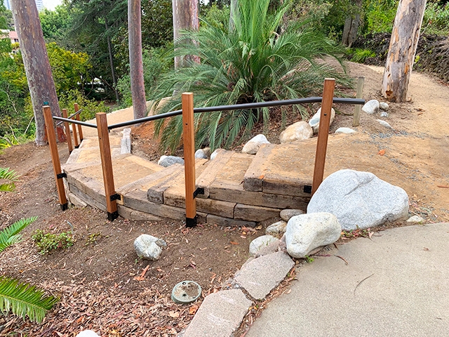 garden path after renovations with handrail and defined stairway